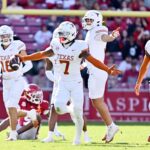 Texas defensive back Jahdae Barron (7) celebrates with teammates after making in interception against Arkansas during the first half of an NCAA college football game Saturday, Nov. 16, 2024, in Fayetteville, Ark. (AP Photo/Michael Woods)