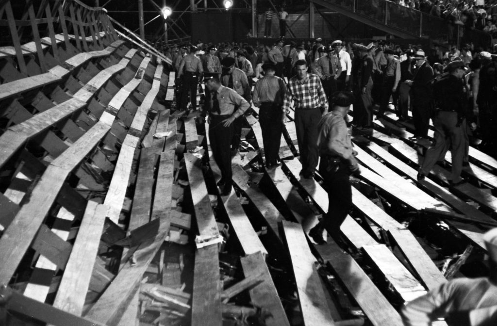 Police inspecting wooden bleachers that collapsed during a football game at Ladd Stadium in Mobile, Alabama.